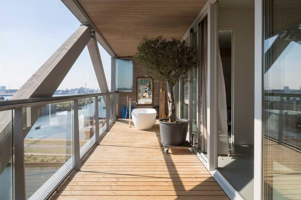 Terraza de madera con ventanas con persianas blancas
